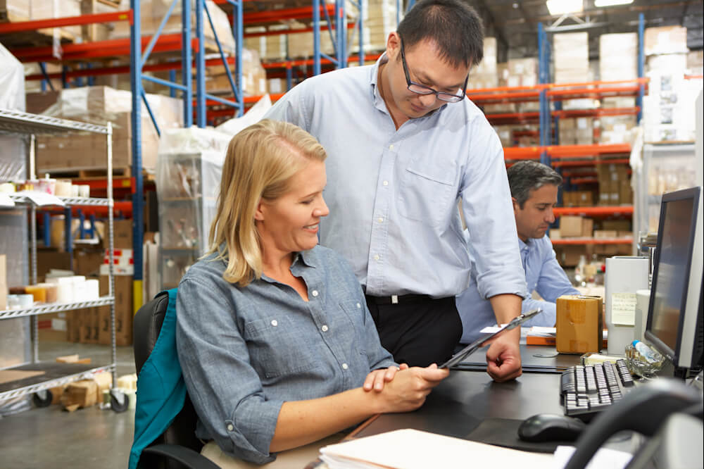 business-colleagues-working-at-desk-in-warehouse-2023-11-27-05-09-58-utc_1